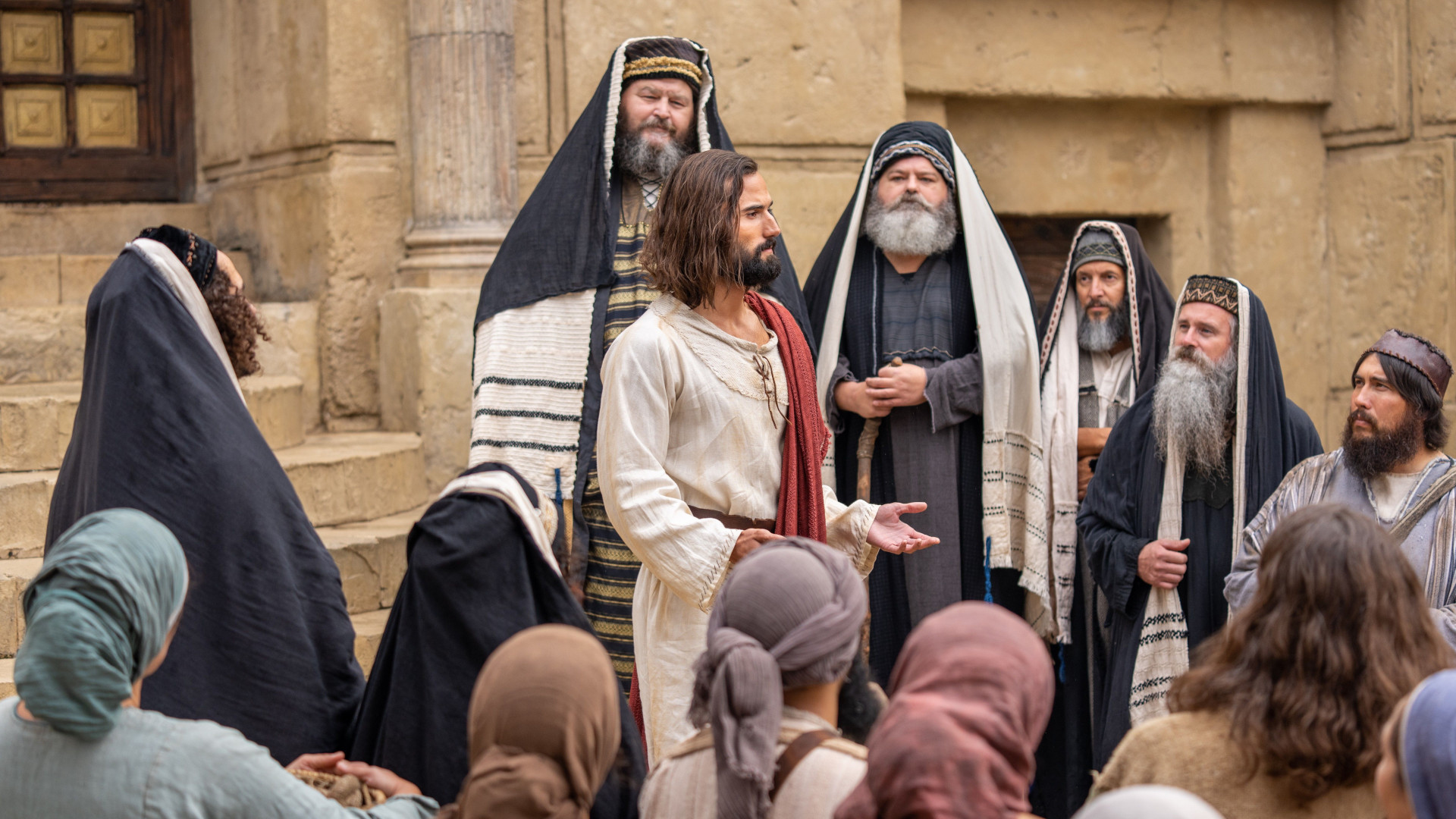 Jesus Christ teaches a crowd in front of the Pharisees at the temple.