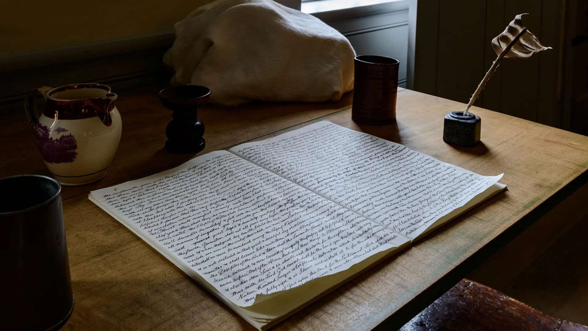 A Book of Mormon Manuscript on a table. Doctrine and Covenants 10-11.