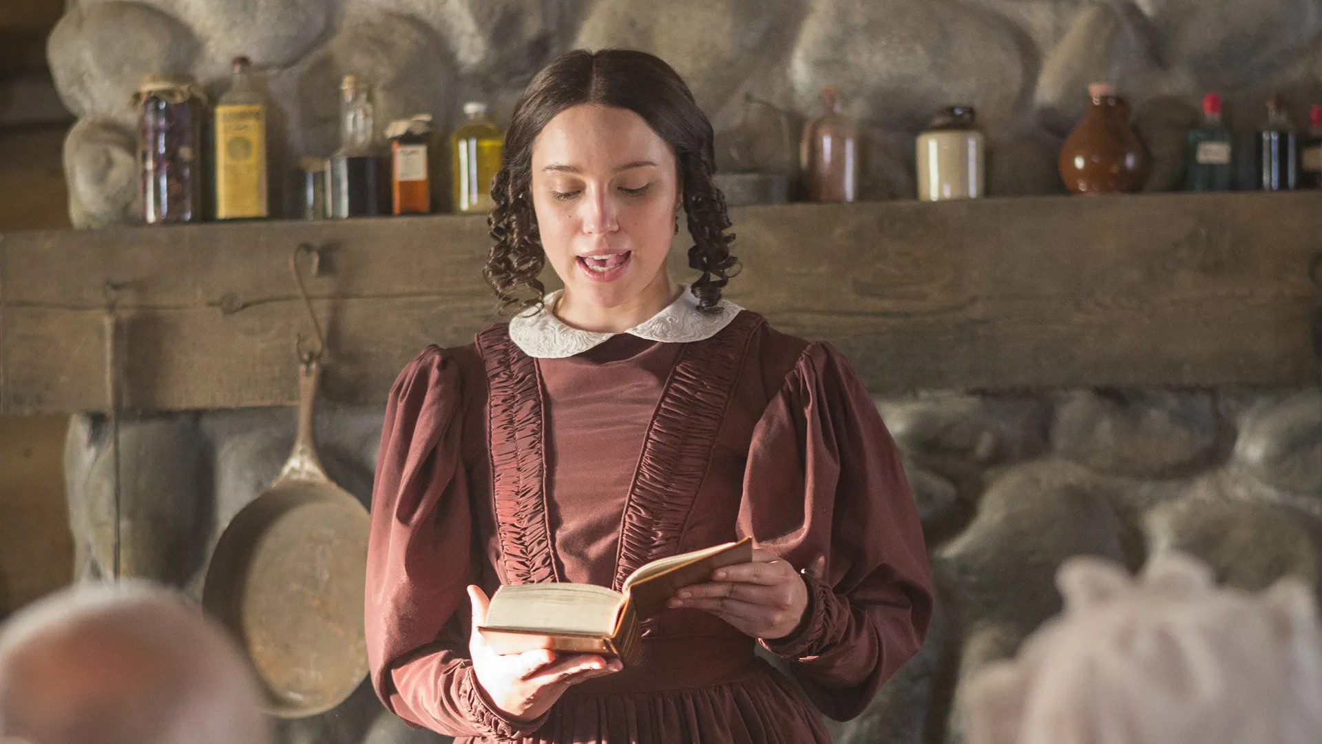 Emma Smith reads from the opening pages of a book in this still from “A Day for the Eternities,” a film produced by The Church of Jesus Christ of Latter-day Saints.