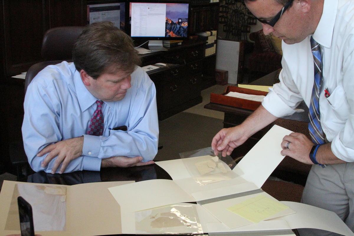 Reid Neilson, left, Assistant Church Historian and Recorder, and Robin Scott Jensen, associate managing historian and project archivist for the Joseph Papers project, go over portions of the original manuscript of the Book of Mormon that have been in the 